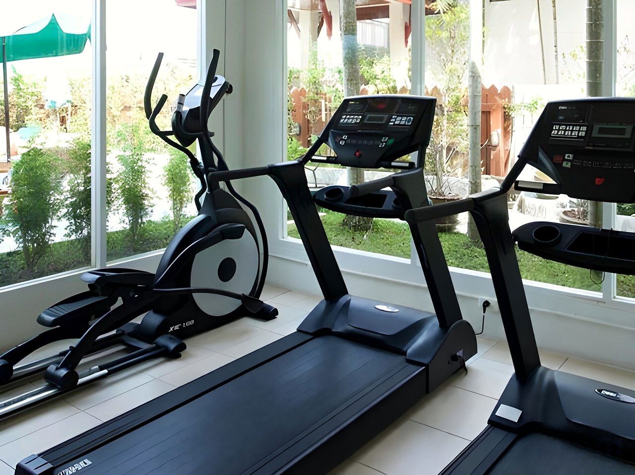 The fitness room, with treadmills by windows onto the garden