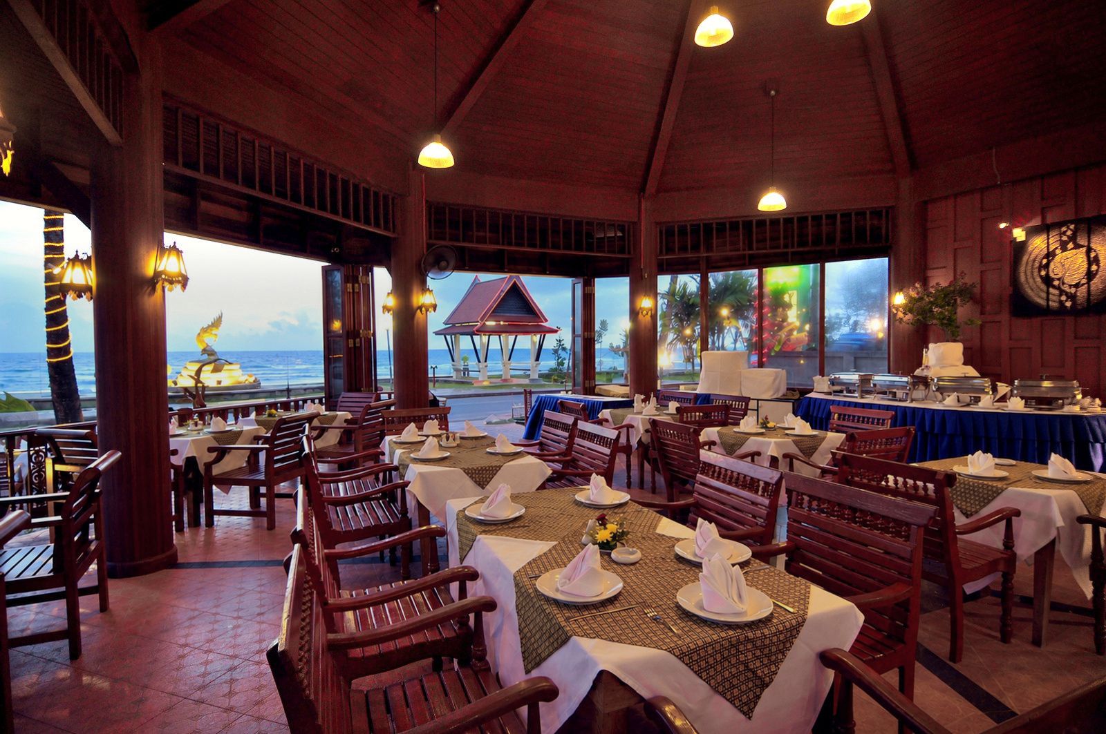 The open-air restaurant at dusk, facing the beach