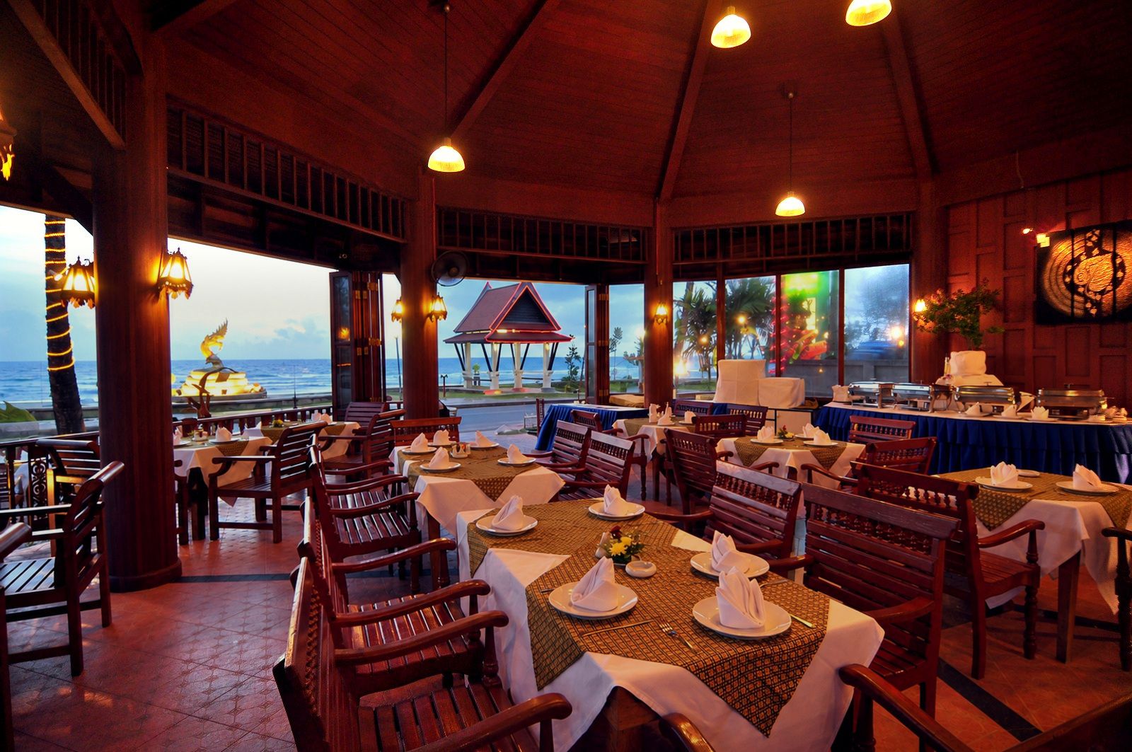 The open-air restaurant at dusk, facing the beach